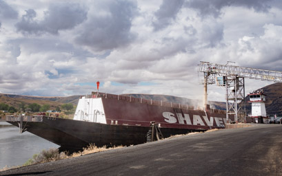 Loading a barge with wheat for shipment downstream.